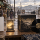 An illustrated early twentieth-century Japanese street behind conceptual game edition items and a vinyl record